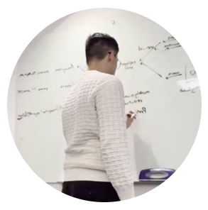 Carlos works on an equation at a whiteboard